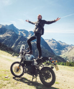 Sam Pelly balanced on Royal Enfield motorbike