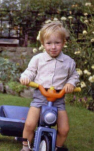 Ralph riding toy bicycle